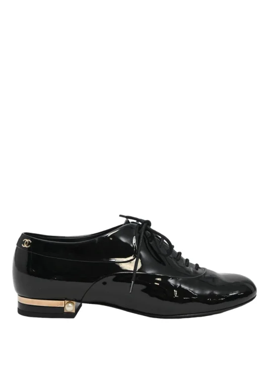 Black patent leather lace-up brogues with gold-tone metallic Coco Mark ankle and heel plaque