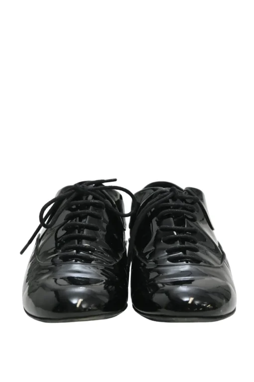 Black patent leather lace-up brogues with gold-tone metallic Coco Mark ankle and heel plaque
