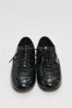 Black patent leather lace-up brogues with gold-tone metallic Coco Mark ankle and heel plaque