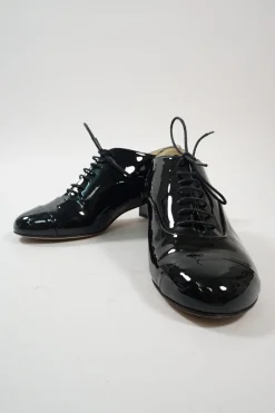 Black patent leather lace-up brogues with Coco Mark ankle plaque and sculpted camellia block heel