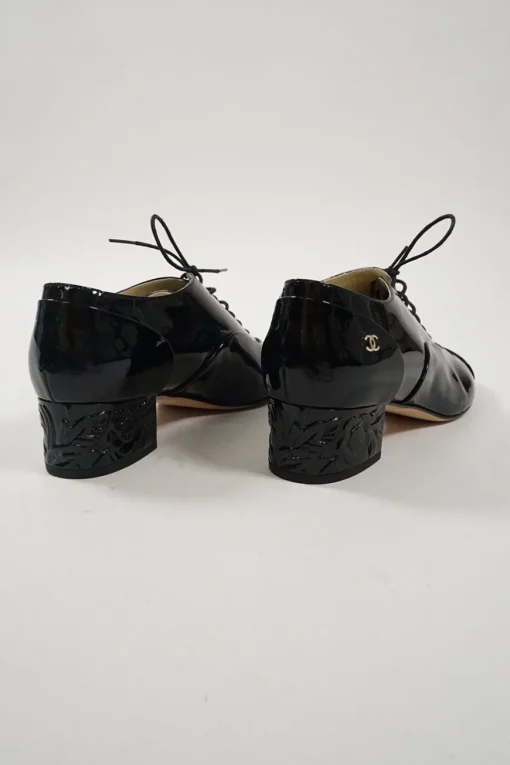 Black patent leather lace-up brogues with Coco Mark ankle plaque and sculpted camellia block heel