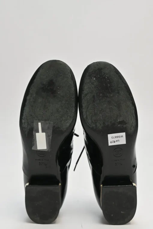 Black patent leather lace-up brogues with gold-tone metallic Coco Mark ankle and heel plaque