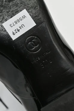 Black patent leather lace-up brogues with gold-tone metallic Coco Mark ankle and heel plaque