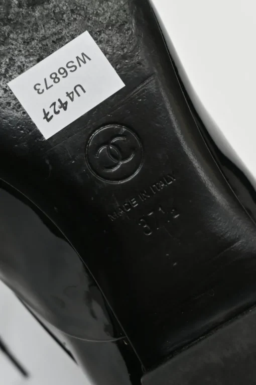 Black patent leather lace-up brogues with gold-tone metallic Coco Mark ankle and heel plaque