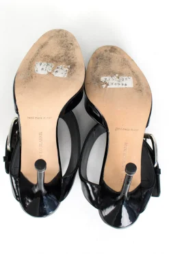 Black patent leather open high-heel pump with silver over-sized buckle detail