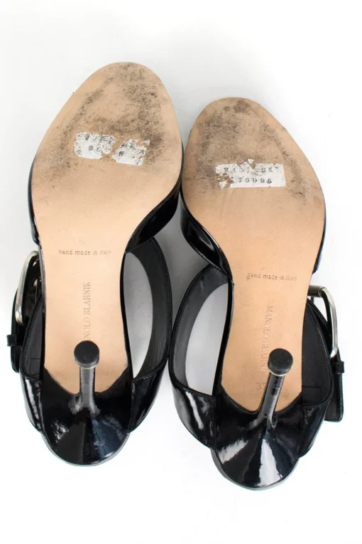 Black patent leather open high-heel pump with silver over-sized buckle detail