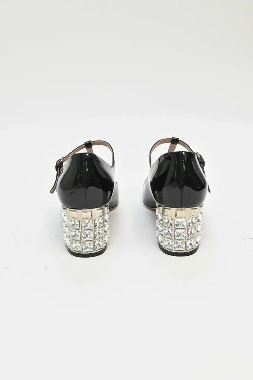 Black patent leather T-strap Mary Jane block heel pumps with crystal-embellished heel