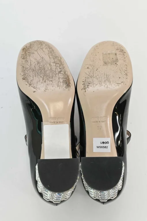 Black patent leather T-strap Mary Jane block heel pumps with crystal-embellished heel