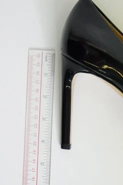 Black patent platform pumps with grosgrain Vara bow wrapped in brand's signature engraved metal plaque