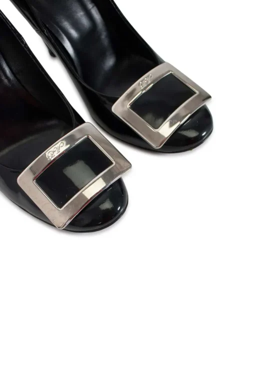 Black patent round toe pump with silver-tone signature square buckle
