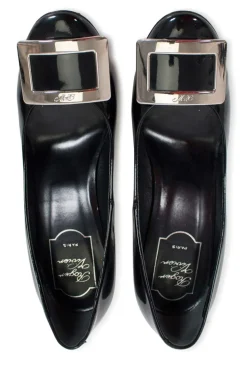 Black patent round toe pump with silver-tone signature square buckle