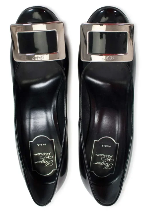Black patent round toe pump with silver-tone signature square buckle