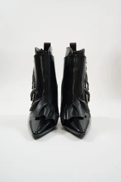 Black polished calfskin and leather pointed toe monk strap-style zip-up ankle booties with ruffle trim