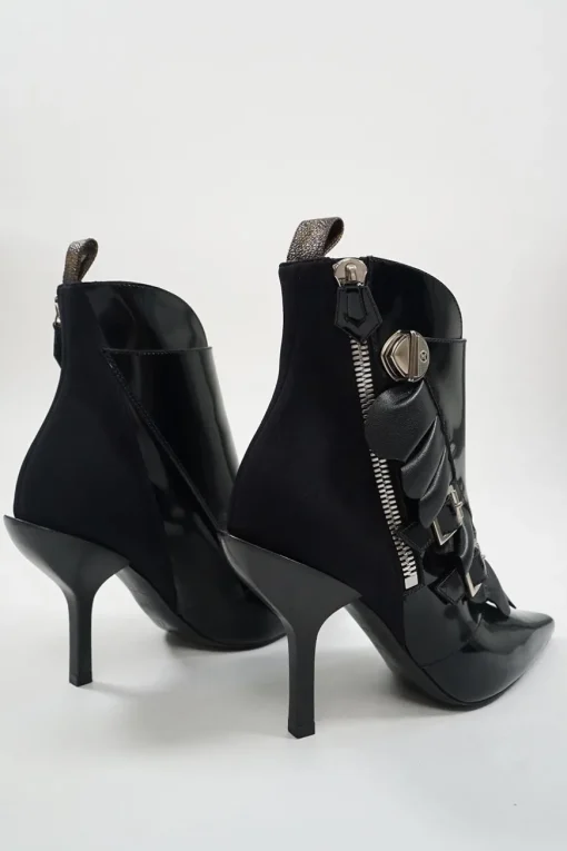 Black polished calfskin and leather pointed toe monk strap-style zip-up ankle booties with ruffle trim