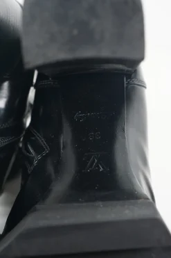Black polished calfskin and rubber lace-up Star Trail combat-style block heel ankle boots
