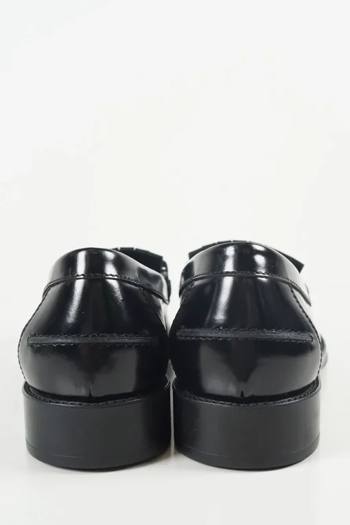 Black polished calfskin double T buckle fringe loafers with textured rubber soles
