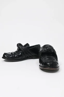 Black polished leather round-toe loafers with knot accents