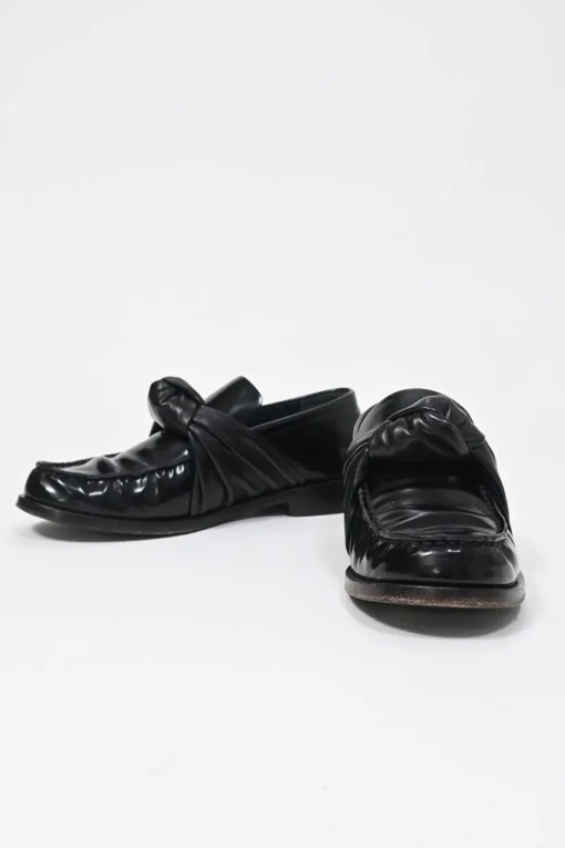 Black polished leather round-toe loafers with knot accents
