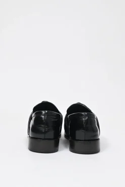 Black polished leather round-toe loafers with knot accents