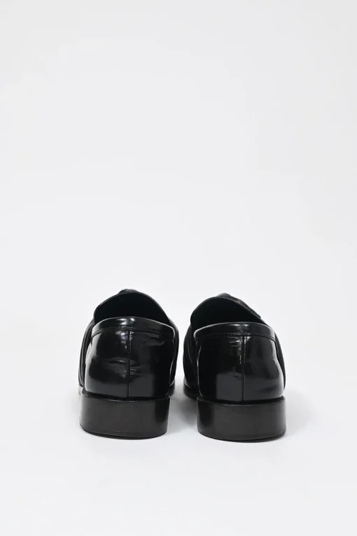Black polished leather round-toe loafers with knot accents
