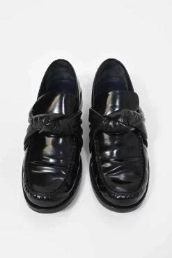 Black polished leather round-toe loafers with knot accents