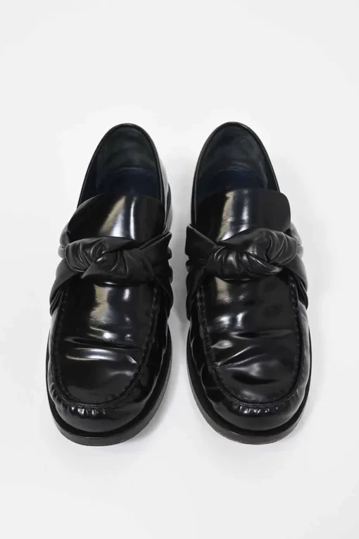 Black polished leather round-toe loafers with knot accents