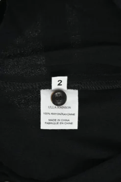 Black rayon pull-on drop-crotch pants with elasticated waistband and side button fly