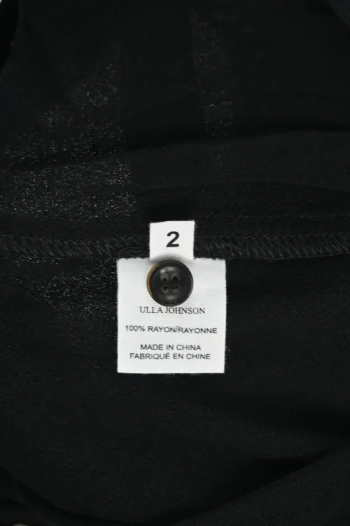 Black rayon pull-on drop-crotch pants with elasticated waistband and side button fly