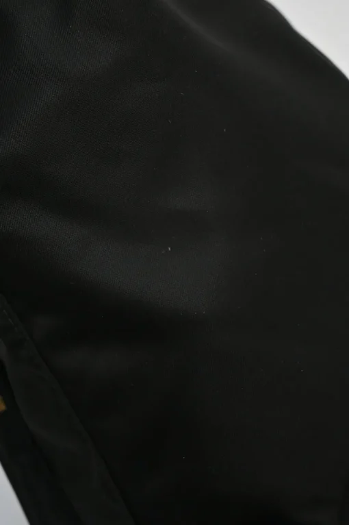 Black re-nylon duet drawstring bucket bag with front zip pocket in gold-tone metallic hardware