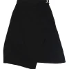 Black silk asymmetric apron-style wrap-front A-line skirt with pull tab fastening at side