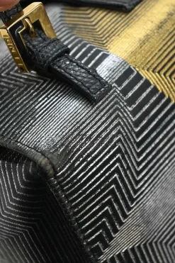 Black, silver, and gold leather shoulder bag with Zucca buckle magnetic snap closure