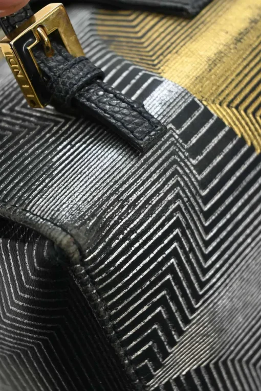 Black, silver, and gold leather shoulder bag with Zucca buckle magnetic snap closure