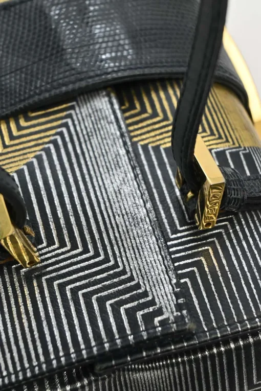 Black, silver, and gold leather shoulder bag with Zucca buckle magnetic snap closure