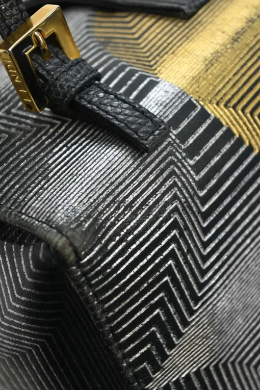Black, silver, and gold leather shoulder bag with Zucca buckle magnetic snap closure