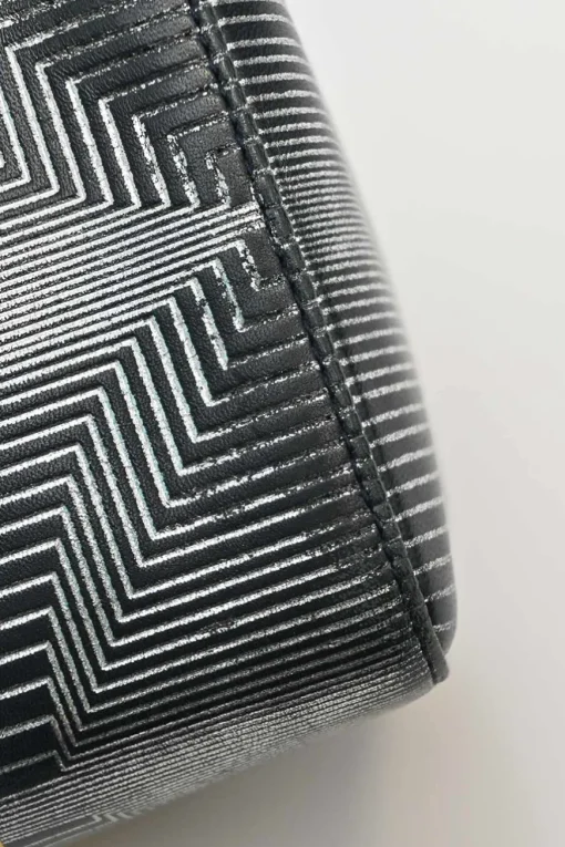 Black, silver, and gold leather shoulder bag with Zucca buckle magnetic snap closure