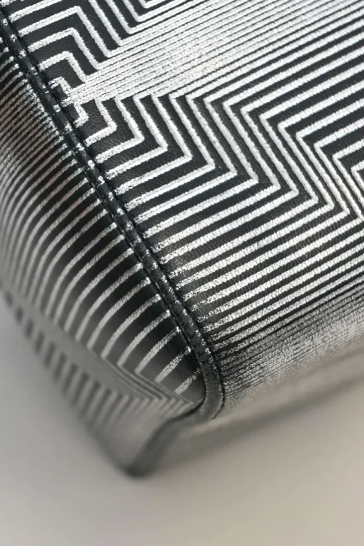 Black, silver, and gold leather shoulder bag with Zucca buckle magnetic snap closure