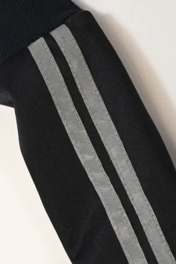 Black stretch-nylon corset style two-piece tracksuit featuring full-zip jacket and high-waist pants with side stripe and lace-up detailing