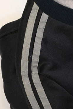 Black stretch-nylon corset style two-piece tracksuit featuring full-zip jacket and high-waist pants with side stripe and lace-up detailing