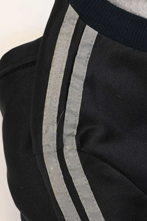 Black stretch-nylon corset style two-piece tracksuit featuring full-zip jacket and high-waist pants with side stripe and lace-up detailing