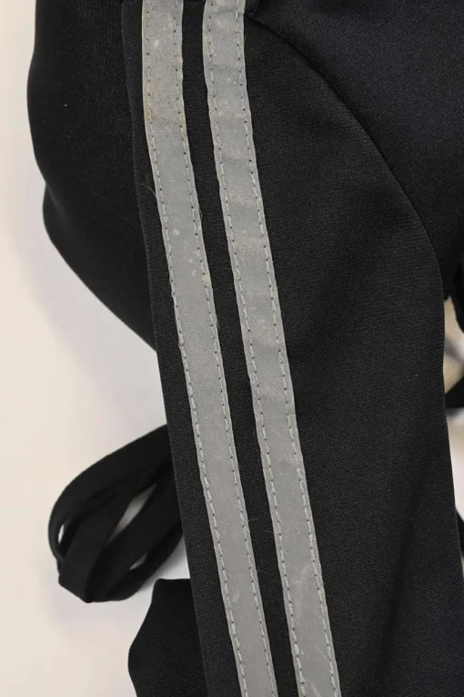 Black stretch-nylon corset style two-piece tracksuit featuring full-zip jacket and high-waist pants with side stripe and lace-up detailing