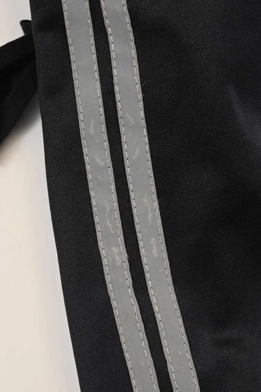 Black stretch-nylon corset style two-piece tracksuit featuring full-zip jacket and high-waist pants with side stripe and lace-up detailing