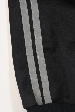 Black stretch-nylon corset style two-piece tracksuit featuring full-zip jacket and high-waist pants with side stripe and lace-up detailing