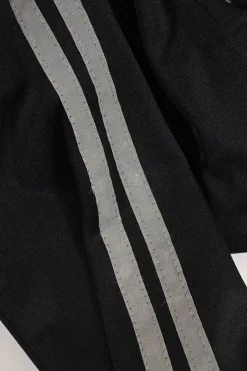 Black stretch-nylon corset style two-piece tracksuit featuring full-zip jacket and high-waist pants with side stripe and lace-up detailing