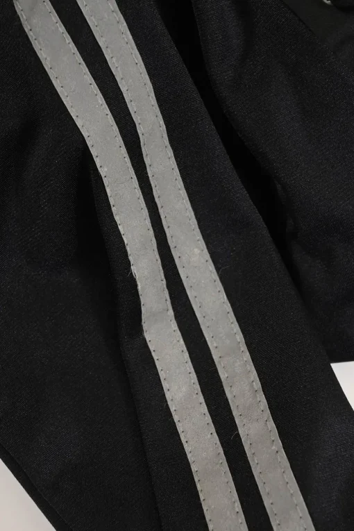 Black stretch-nylon corset style two-piece tracksuit featuring full-zip jacket and high-waist pants with side stripe and lace-up detailing