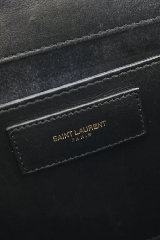 Black suede shoulder bag with gold tone chain and stitched corner fold up front detail