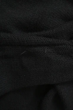 Black virgin wool keyhole knit top with metallic plaque appliqué
