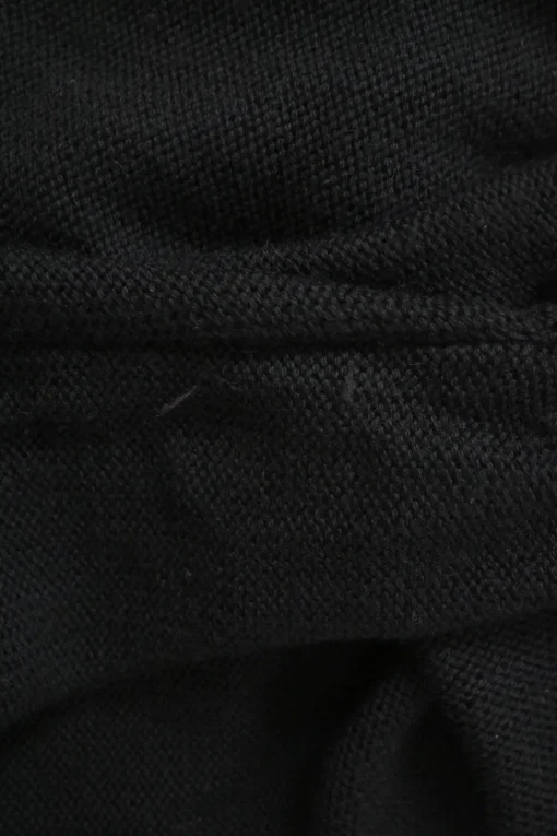 Black virgin wool keyhole knit top with metallic plaque appliqué