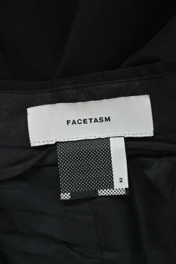 Black wool asymmetrical pants with wrap-front apron-style overlay