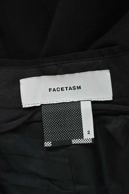 Black wool asymmetrical pants with wrap-front apron-style overlay