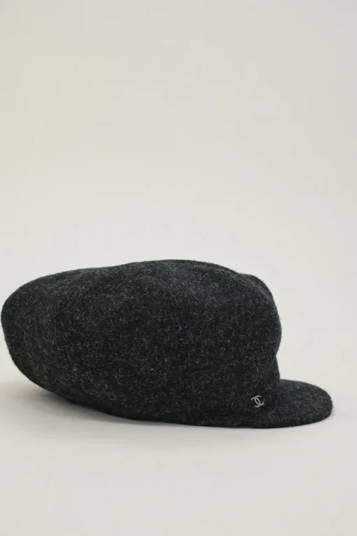 Black wool felt newsboy cap with metallic Coco Mark plaque appliqué